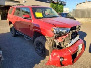 picture of a toyota 4runner that has been totaled due to a car accident. The appraiser is inspecting the vehicle to dispute the insurance company's low value.